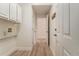 Spacious mudroom with built-in cabinets, coat rack, and durable wood-look flooring at 401 Wellwood Way, Roswell, GA 30075