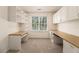 Bright home office featuring custom built-ins, shelving, and a window for natural light at 401 Wellwood Way, Roswell, GA 30075