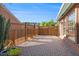 Enclosed brick patio with wooden fence providing privacy and space for outdoor lounging at 401 Wellwood Way, Roswell, GA 30075
