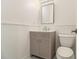 Charming powder room featuring a vanity with storage, a decorative mirror, and beadboard wainscoting at 401 Wellwood Way, Roswell, GA 30075