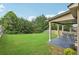 This backyard offers a tranquil setting with a covered patio, creating a relaxing space at 931 Sublime Trl, Canton, GA 30114