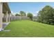 A vast backyard space with a covered patio and lush lawn at 931 Sublime Trl, Canton, GA 30114