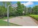 Outdoor basketball court surrounded by trees and landscaping, perfect for recreational activities at 931 Sublime Trl, Canton, GA 30114
