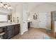 Bright bathroom featuring double sink vanity, a glass enclosed shower and neutral tile flooring at 931 Sublime Trl, Canton, GA 30114