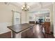 Dining area with hardwood floors, a wooden table, chandelier, and view to office space at 931 Sublime Trl, Canton, GA 30114