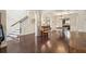Inviting living room showcasing hardwood floors, a staircase, a piano, and a glimpse into the kitchen at 931 Sublime Trl, Canton, GA 30114