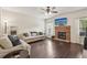 Cozy living room with fireplace, hardwood floors, comfortable seating, and a mounted TV at 931 Sublime Trl, Canton, GA 30114