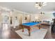 Spacious game room area featuring a pool table with hardwood floors and natural lighting at 931 Sublime Trl, Canton, GA 30114