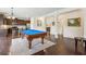 Open-concept room with pool table, hardwood flooring, and kitchen view at 931 Sublime Trl, Canton, GA 30114