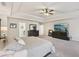Expansive main bedroom boasts tray ceilings, neutral carpet, dark wood furniture, and a mounted television at 931 Sublime Trl, Canton, GA 30114