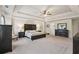 Large main bedroom featuring a tray ceiling, carpeting, and stylish dark wood furniture at 931 Sublime Trl, Canton, GA 30114