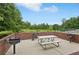 Outdoor picnic area overlooking a pond features grills and a table for outdoor dining at 931 Sublime Trl, Canton, GA 30114