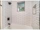 A bright white bathtub and shower combo with classic subway tile surround at 1917 Connally Dr, Atlanta, GA 30344