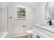 Bathroom featuring modern sink, shower and tub combo with subway tile and window at 1917 Connally Dr, Atlanta, GA 30344