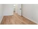 An empty bedroom with light brown, wood look flooring at 1917 Connally Dr, Atlanta, GA 30344