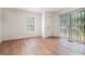An empty bedroom with a patio door and window providing outside light at 1917 Connally Dr, Atlanta, GA 30344