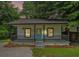 Charming home with a inviting porch, teal front door, and mature trees at 1917 Connally Dr, Atlanta, GA 30344