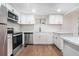 Modern kitchen featuring white cabinets, stainless steel appliances, subway tile backsplash, and quartz countertops at 1917 Connally Dr, Atlanta, GA 30344