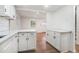 Bright eat-in kitchen featuring white cabinetry, countertops, and stainless steel appliances at 1917 Connally Dr, Atlanta, GA 30344