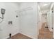 Bright laundry room features wooden floors, utility connections, and shelving for storage at 1917 Connally Dr, Atlanta, GA 30344