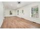 Bright and airy living room with newly installed flooring, several windows, and an updated ceiling fan at 1917 Connally Dr, Atlanta, GA 30344