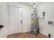 Utility room featuring water heater, electrical panel, and access to the outside at 1917 Connally Dr, Atlanta, GA 30344