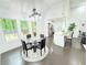 Bright dining area with a glass-top table, dark wood floors, and large windows overlooking the yard at 195 Burbank Nw Dr, Atlanta, GA 30314