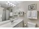 Bright bathroom with a well-lit vanity, a framed mirror, and decorative wall art at 2903 Brookshire Way, Duluth, GA 30096