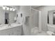 Bathroom featuring white cabinets, a bathtub with shower and toilet at 2903 Brookshire Way, Duluth, GA 30096