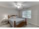 Calm bedroom with carpet has a sunny window view and natural wood bedframe with a side table at 2903 Brookshire Way, Duluth, GA 30096