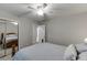 Bedroom with a ceiling fan, double window, and closet with mirrored sliding doors at 2903 Brookshire Way, Duluth, GA 30096