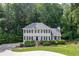 Inviting two-story home boasting lush landscaping, a manicured lawn, and a serene wooded backdrop at 2903 Brookshire Way, Duluth, GA 30096