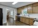 Well-lit kitchen boasts wood cabinetry, stainless steel appliances, and hardwood floors at 2903 Brookshire Way, Duluth, GA 30096