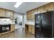 Appealing kitchen showcases hardwood floors, black appliances, and lots of cabinet storage at 2903 Brookshire Way, Duluth, GA 30096