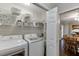 Convenient laundry room includes shelving for storage and access to dining room with lots of sunlight at 2903 Brookshire Way, Duluth, GA 30096
