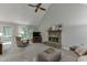 Cozy living room features a stone fireplace, ceiling fan, and access to the outdoor deck at 2903 Brookshire Way, Duluth, GA 30096
