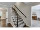 Elegant stairway featuring hardwood floors, plush carpet, and classic white trim at 2903 Brookshire Way, Duluth, GA 30096