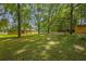 Expansive backyard with mature trees and a storage shed at 326 Acaro Ct, Ellenwood, GA 30294