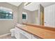 Bright bathroom features an extended vanity and ample natural light from the window at 326 Acaro Ct, Ellenwood, GA 30294
