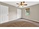 Bedroom has neutral walls, plush carpeting, a window with blinds, and a double door closet at 326 Acaro Ct, Ellenwood, GA 30294