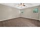 Spacious bedroom features neutral walls, plush carpeting, a ceiling fan, and natural light from windows at 326 Acaro Ct, Ellenwood, GA 30294