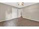 Neutral bedroom features plush carpeting, ceiling fan and a closet for ample storage at 326 Acaro Ct, Ellenwood, GA 30294