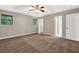 Bedroom featuring neutral walls, carpet flooring, ceiling fan, with doorways to closet and bath at 326 Acaro Ct, Ellenwood, GA 30294