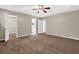 Bedroom with neutral walls, plush carpeting, ceiling fan, and doorways leading to bath and closet at 326 Acaro Ct, Ellenwood, GA 30294
