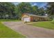Home featuring a driveway with basketball hoop, attached garage, and manicured front yard at 326 Acaro Ct, Ellenwood, GA 30294