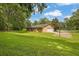 A view of the home and yard from a distance including the basketball hoop at 326 Acaro Ct, Ellenwood, GA 30294