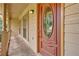 Close-up of a traditional front door featuring decorative glass, sidelights, and a covered porch at 326 Acaro Ct, Ellenwood, GA 30294