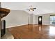 Bright living room with hardwood floors, a ceiling fan, and a brick fireplace at 326 Acaro Ct, Ellenwood, GA 30294