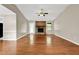 Inviting living room featuring hardwood floors, natural light, and a brick fireplace at 326 Acaro Ct, Ellenwood, GA 30294