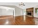 Open-concept living room showcasing hardwood floors and a brick fireplace at 326 Acaro Ct, Ellenwood, GA 30294